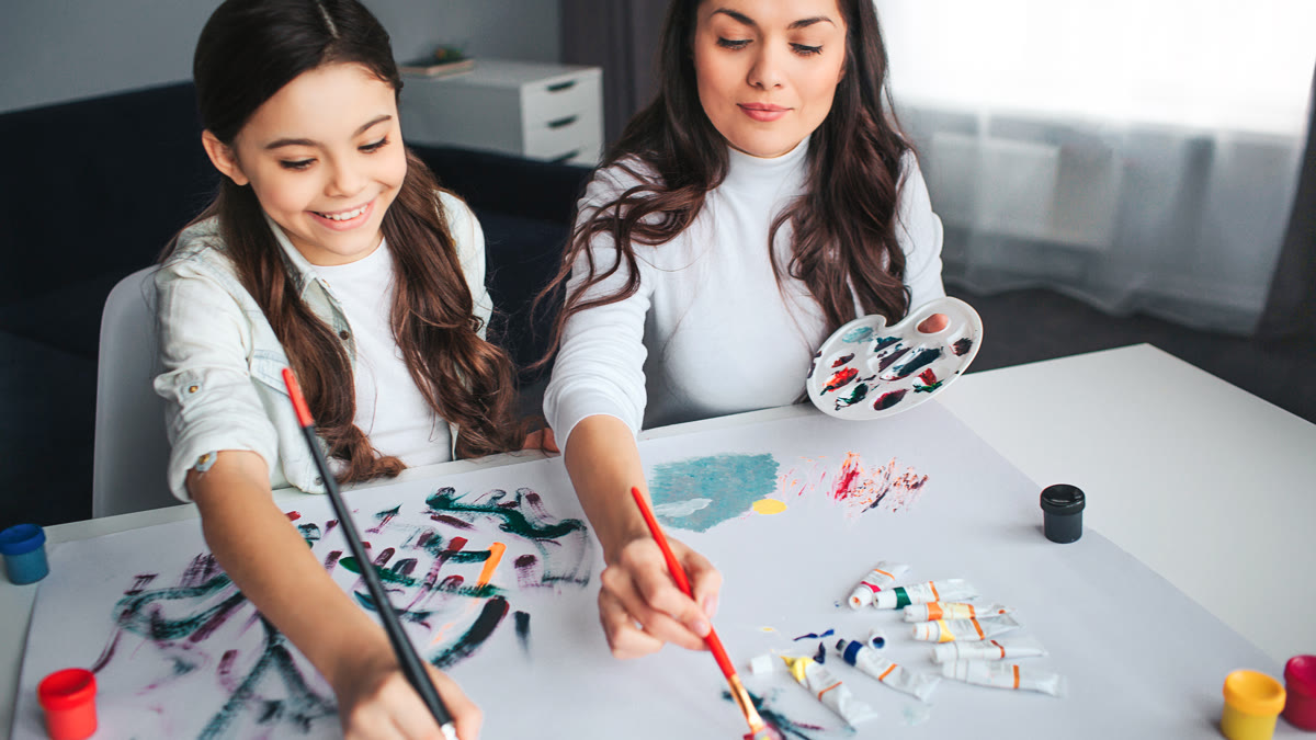 Parent and child learning together through a hands-on painting activity